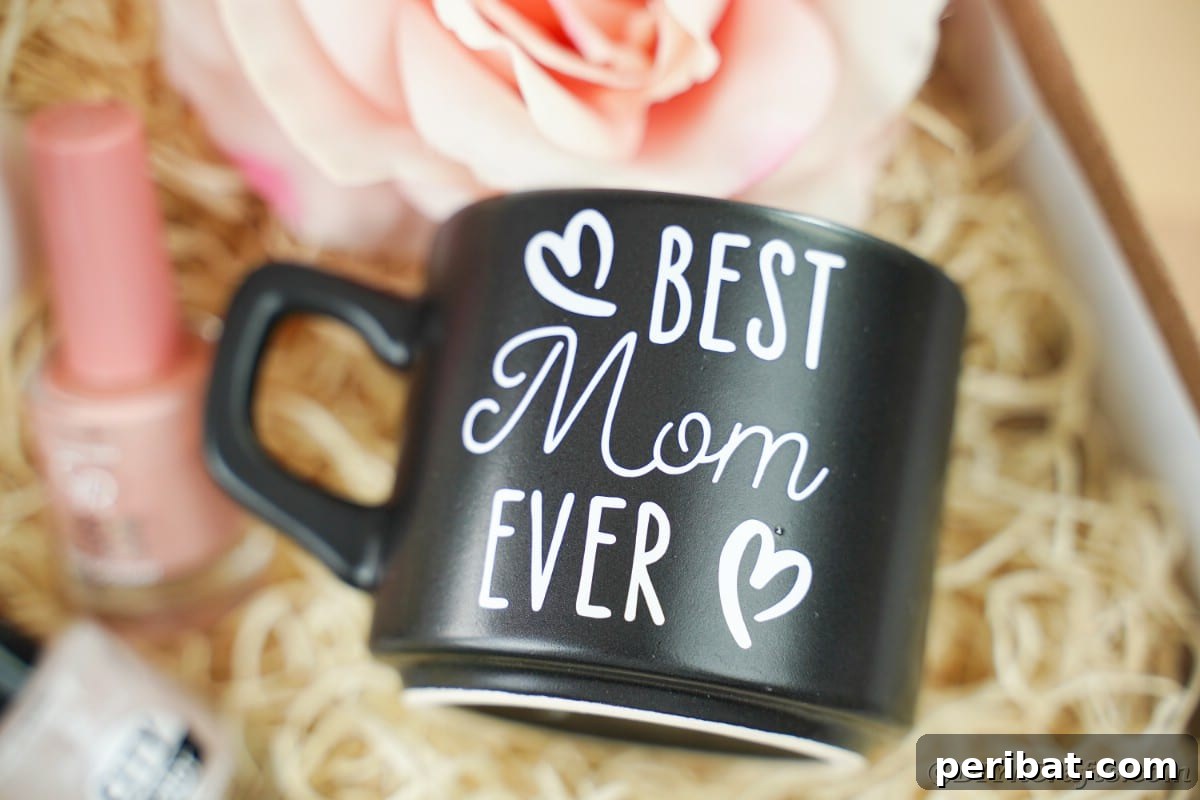 Close-up view of a sleek black coffee mug featuring the heartfelt message 'Best Mom Ever' in elegant white vinyl.