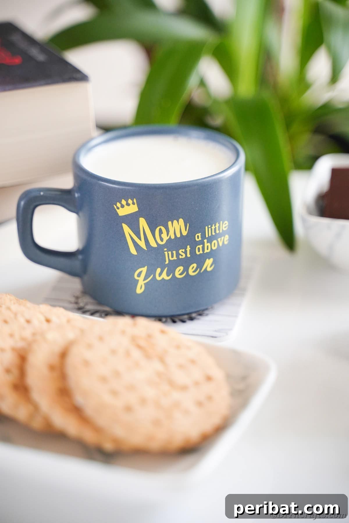 A vibrant blue mug featuring the message 'Mom is a level above queen' displayed on a table, highlighting another creative design.