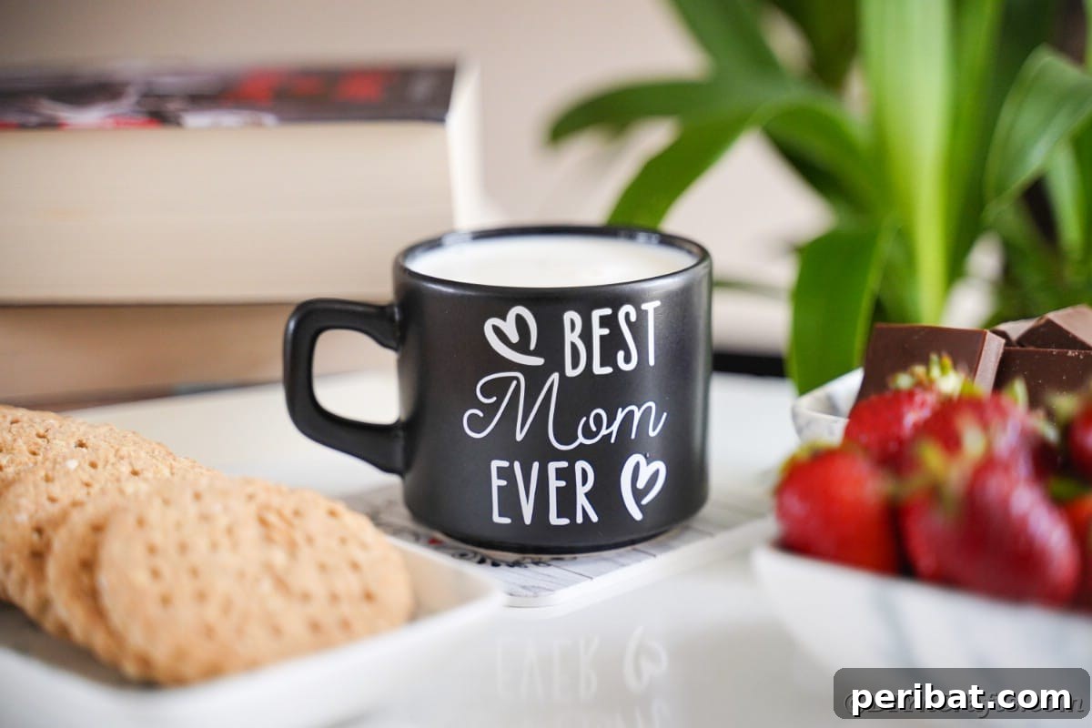 A charming 'Best Mom Ever' mug placed on a table next to a tray of freshly baked cookies, emphasizing its gift potential.