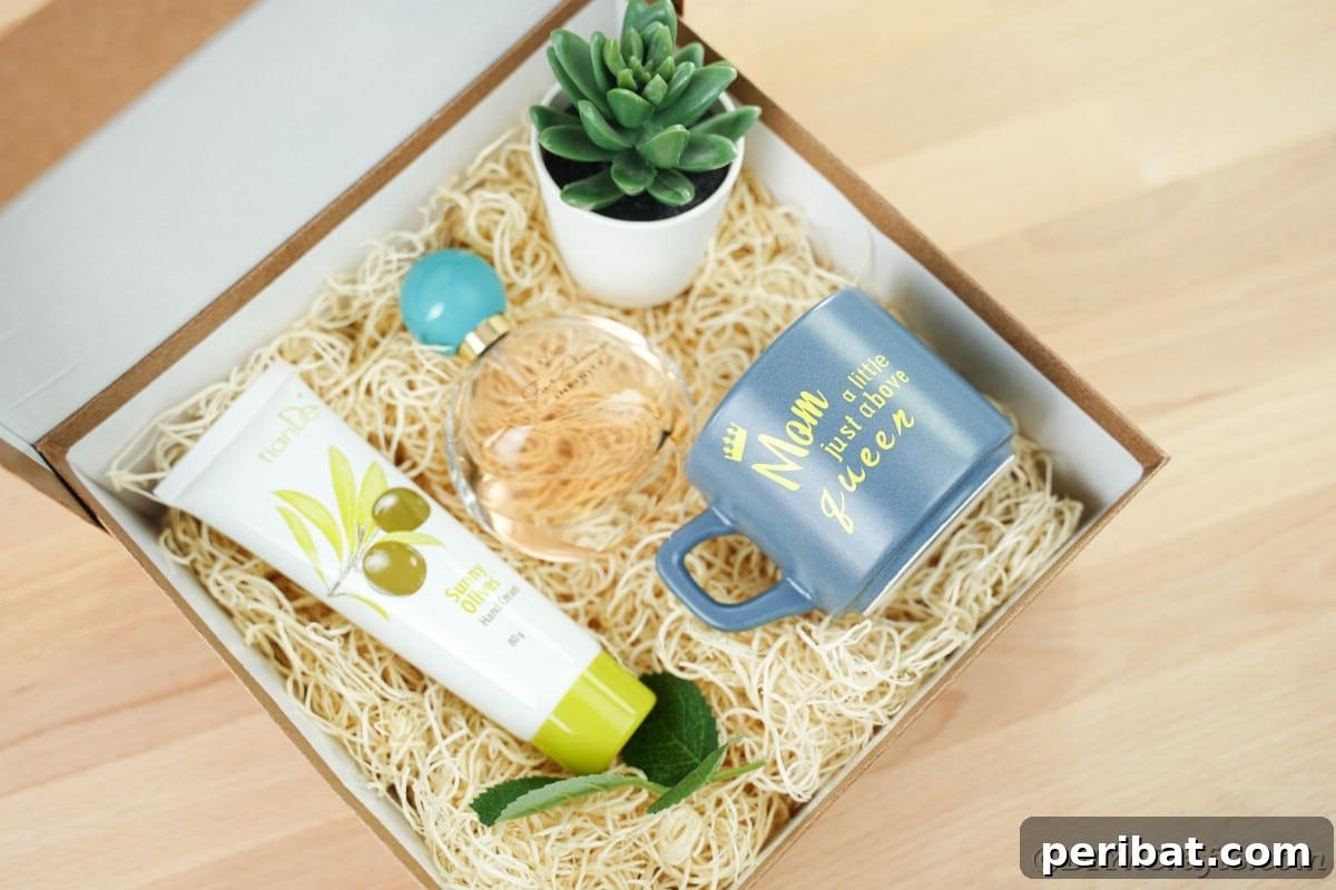 A charming gift box filled with faux hay, a tube of lotion, a small potted plant, and a beautiful blue custom mug, ready for a special mom.