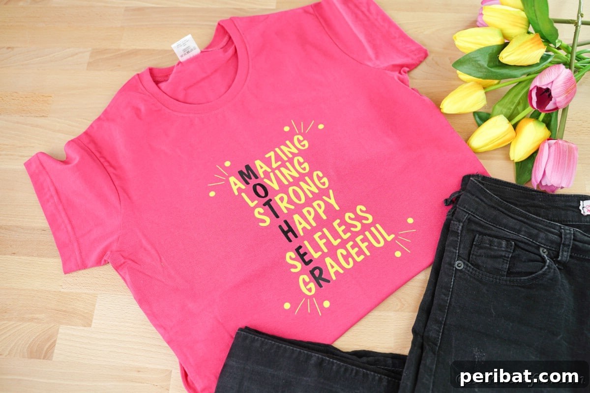Pink custom Mother's Day t-shirt next to black jeans