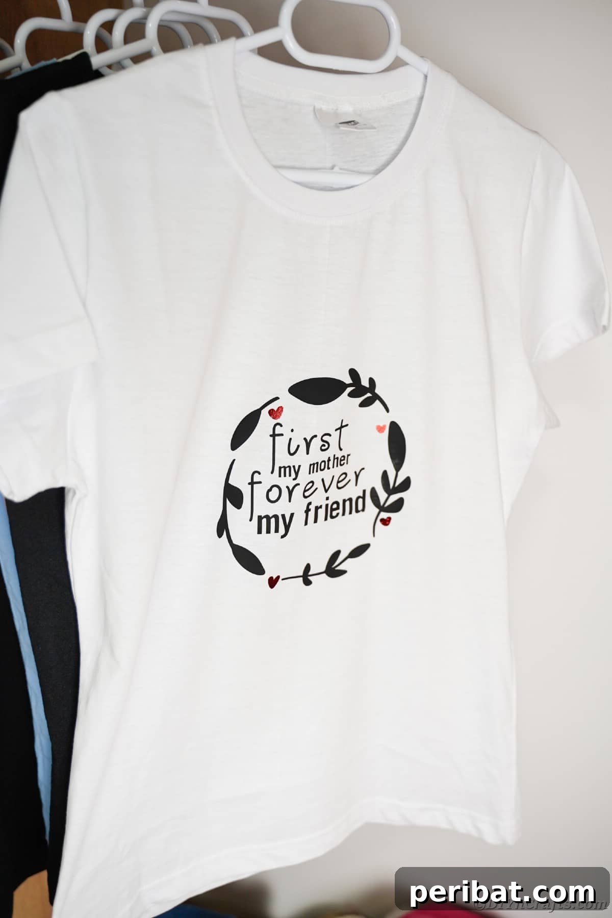 White custom Mother's Day shirt hanging in a closet