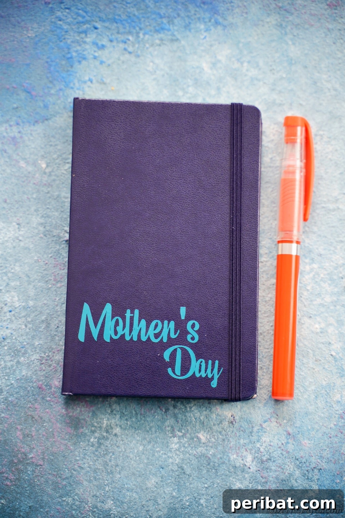 Craft Personalized Vinyl Journals for Mother's Day 14 Dark blue journal with light blue mothers day printed on bottom corner next to orange pen