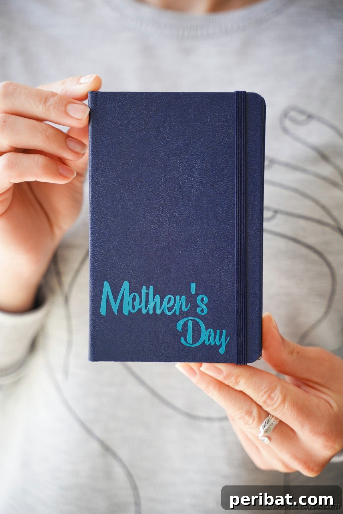 Craft Personalized Vinyl Journals for Mother's Day 17 Woman in gray holding dark blue journal