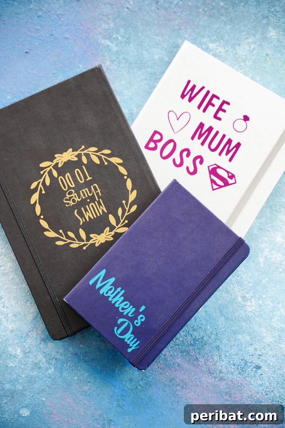 Craft Personalized Vinyl Journals for Mother's Day 6 Black blue and gray journals stacked on blue table