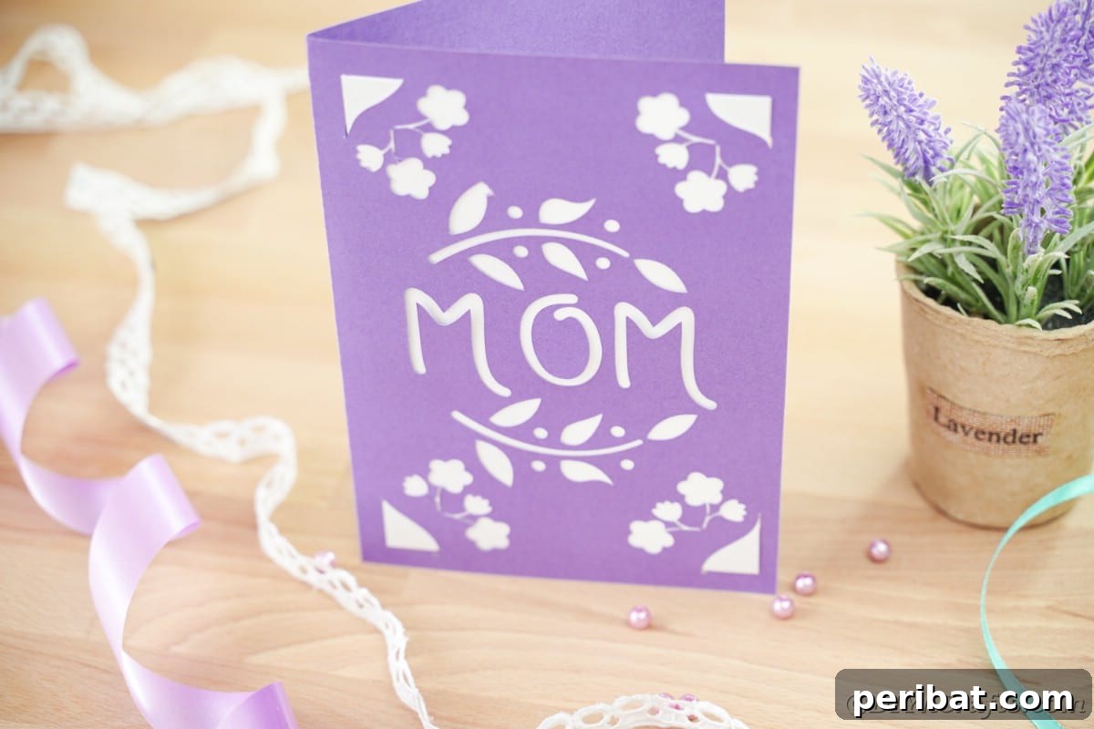 Purple mothers day card sitting on table by potted plant
