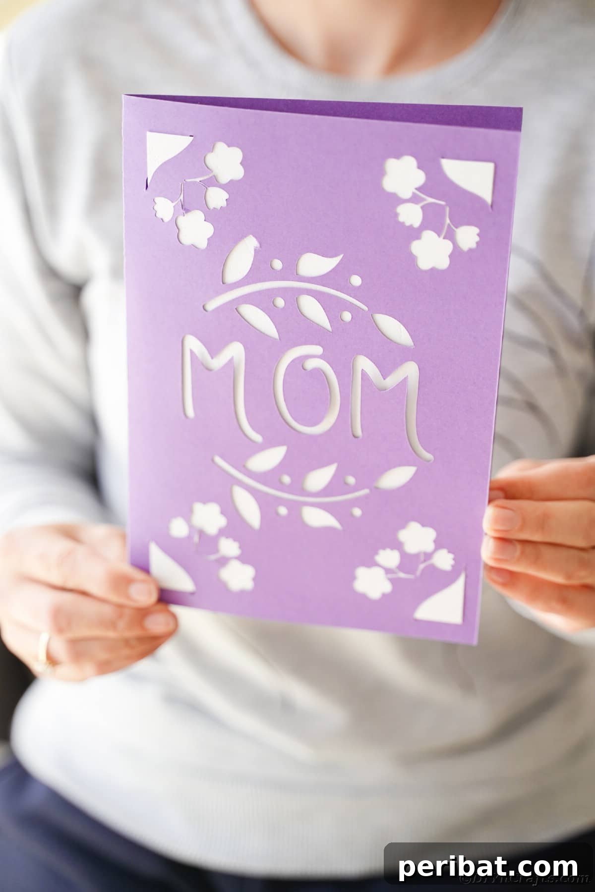 Woman holding purple mothers day card