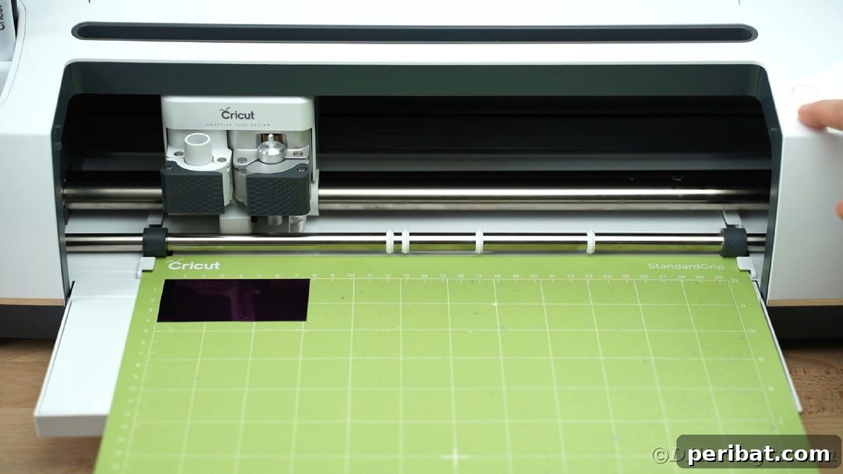 Cricut mat loading into Cricut Maker, initiating the cutting process