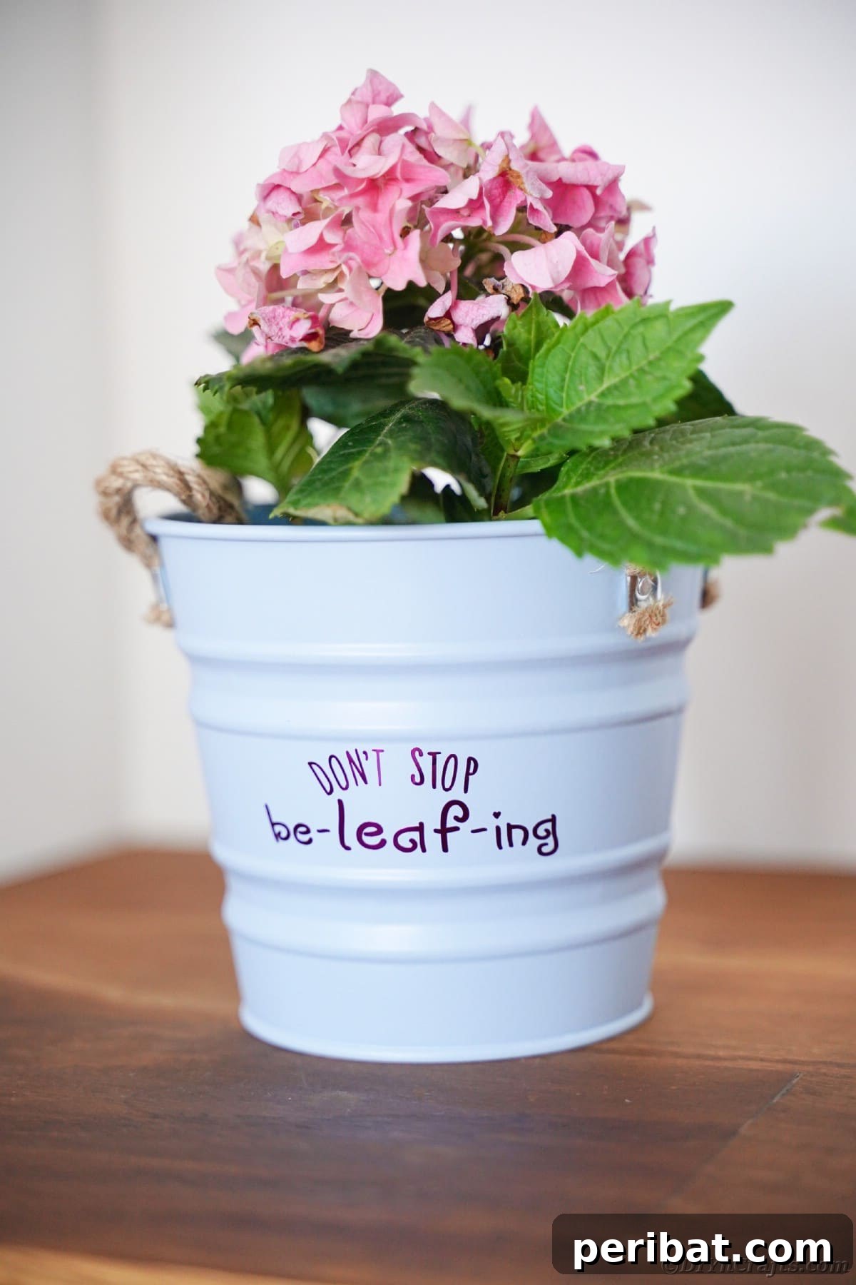 White bucket with purple message on table, presenting a delightful gift idea