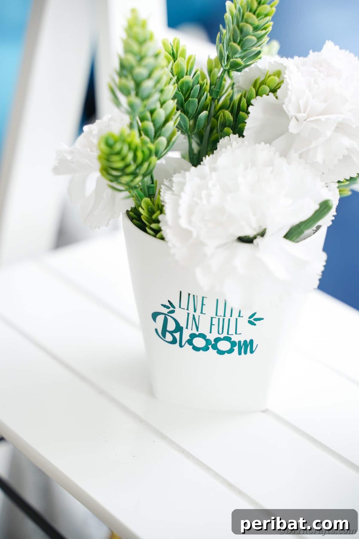 White bucket on shelf with teal lettering, serving as a constant source of inspiration