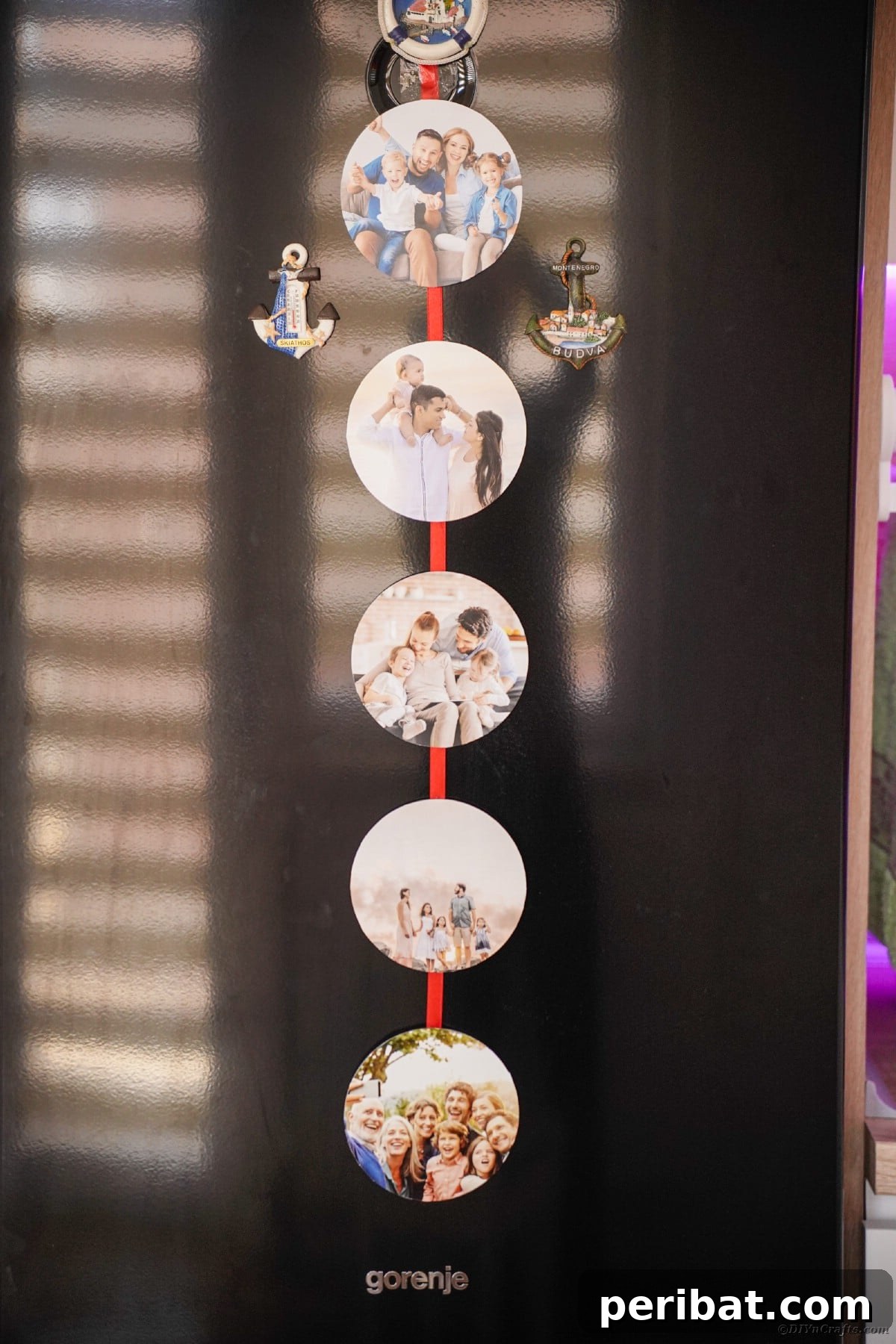 A festive red ribbon photo holder, complete with personalized pictures, elegantly hung on a refrigerator using magnets, adding a pop of color and warmth to the kitchen.