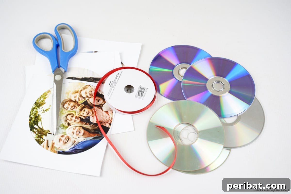 Creative CD Upcycle: DIY Photo Garland for Memories 4 Various crafting supplies for a DIY photo ribbon project neatly arranged on a white table, including old CDs, ribbons, glue, and scissors.