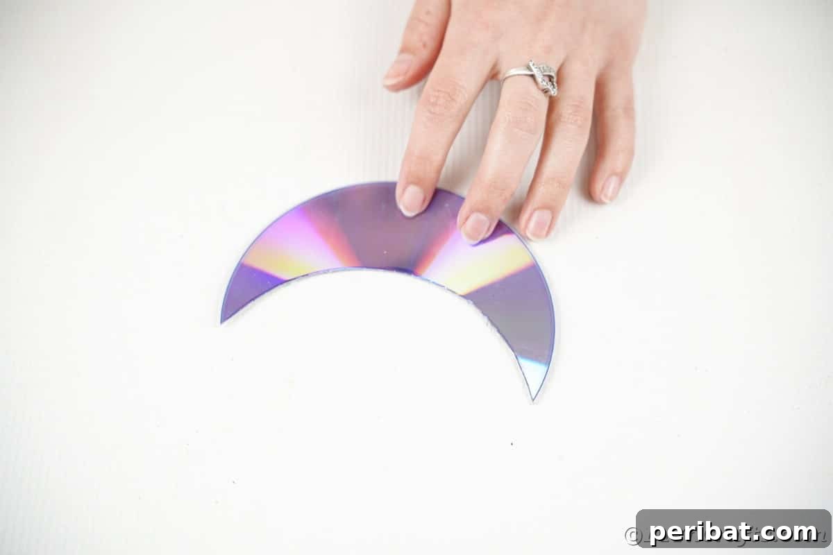 Celestial Sparkle DIY Upcycled CD Moon and Stars Baby Mobile 12 Half moon shape CD on table