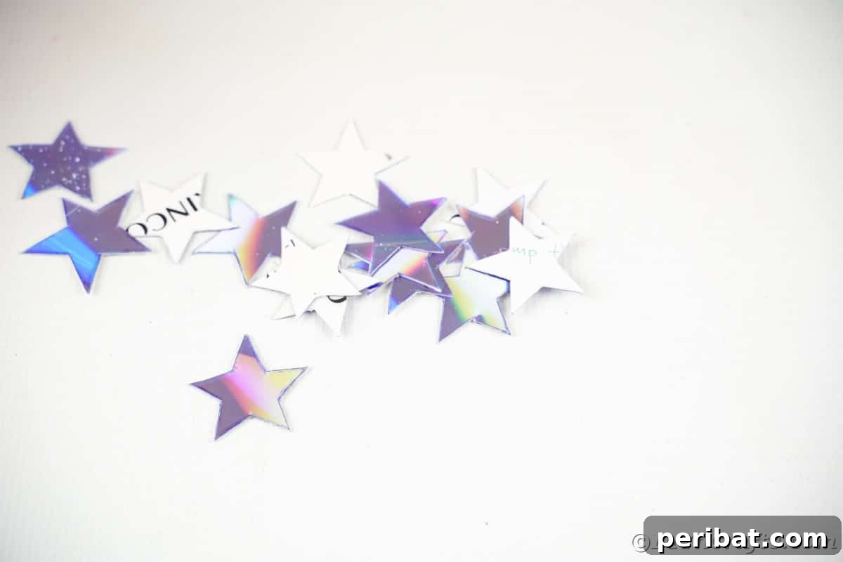 Celestial Sparkle DIY Upcycled CD Moon and Stars Baby Mobile 15 CD stars in pile on white counter