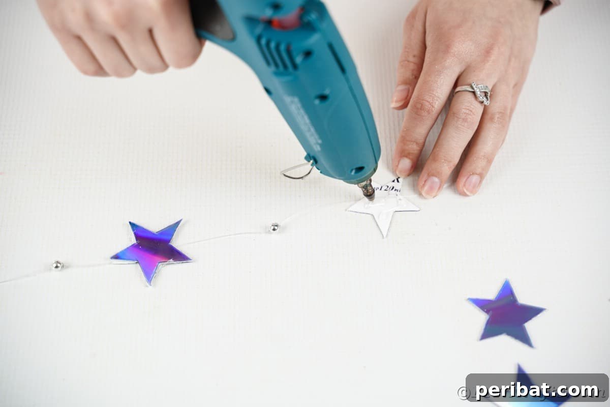 Celestial Sparkle DIY Upcycled CD Moon and Stars Baby Mobile 18 Adding lue to star