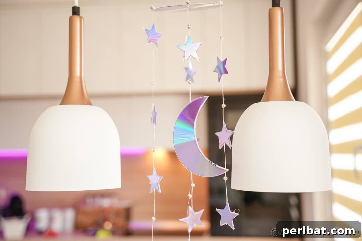 Celestial Sparkle DIY Upcycled CD Moon and Stars Baby Mobile 5 Mobile hanging from ceiling with stars and moon shapes