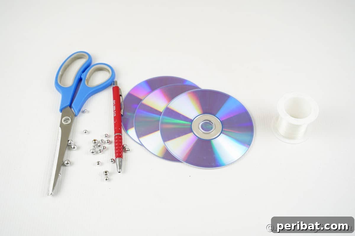 Celestial Sparkle DIY Upcycled CD Moon and Stars Baby Mobile 9 Supplies for making baby mobile on white table