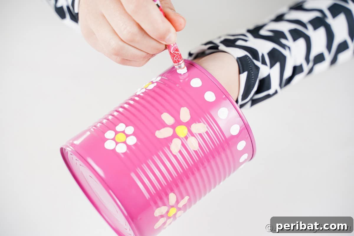 Painting white dots onto pink can