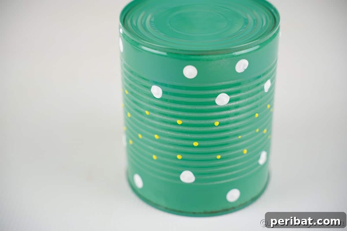 Green tin can with white and yellow dots