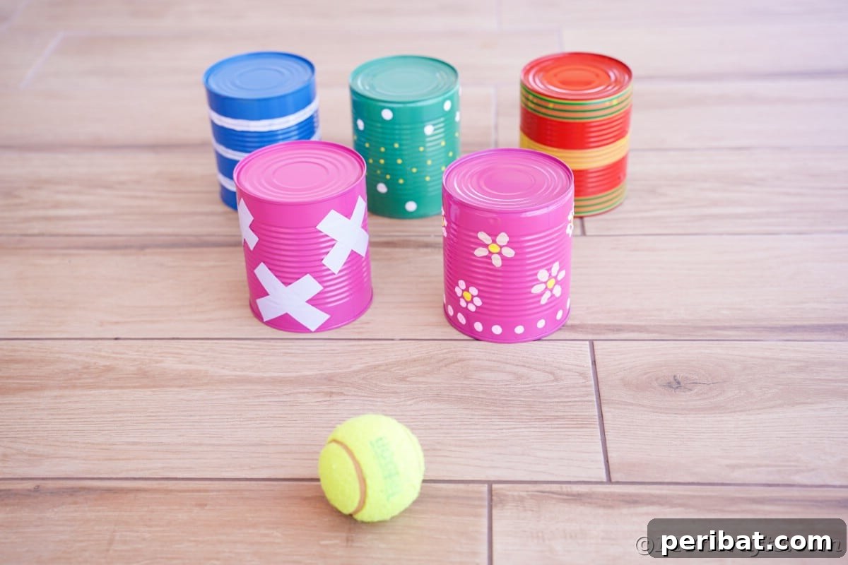 Painted cans on wood flooring with tennis ball
