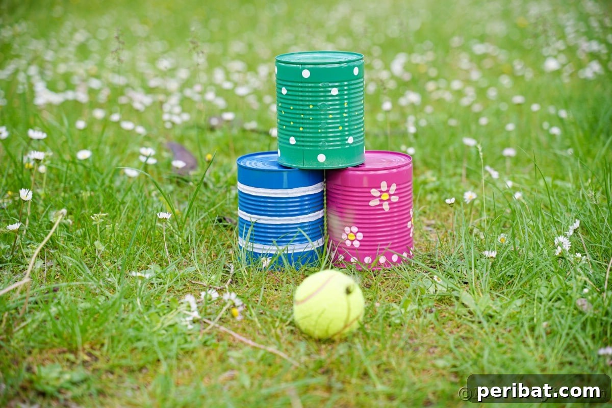 Blue pink and green tin cans on grass 