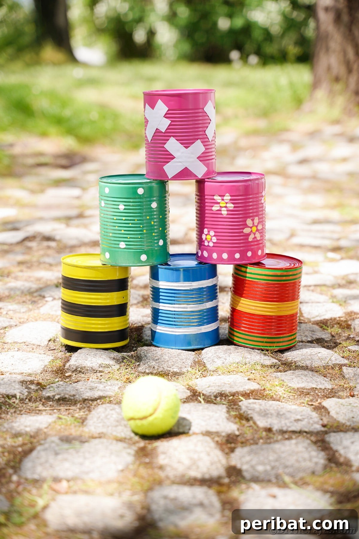 Stacked tin cans on cobblestone