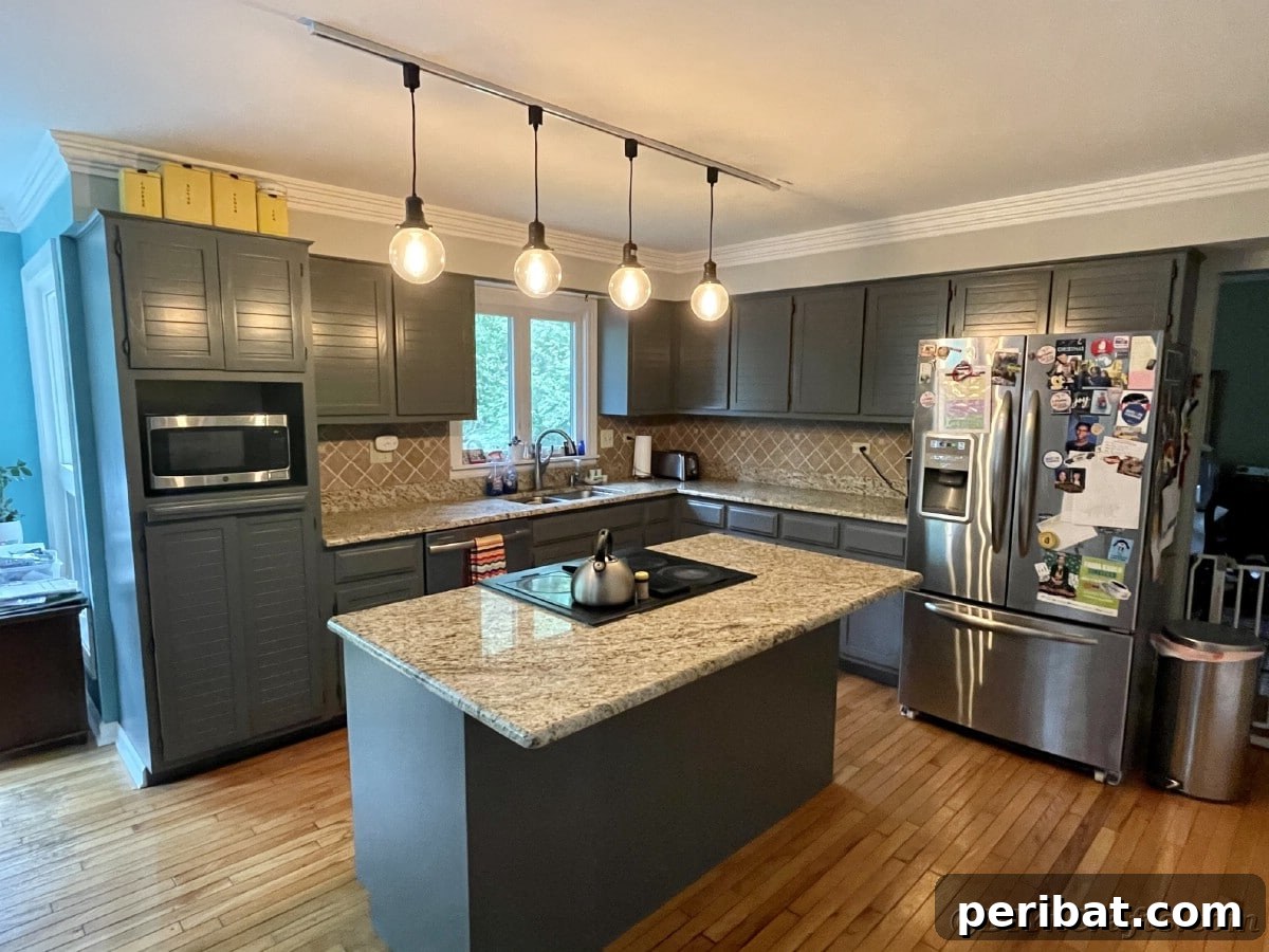 Large island in center of kitchen with sleek gray cabinets, showcasing a modern kitchen aesthetic