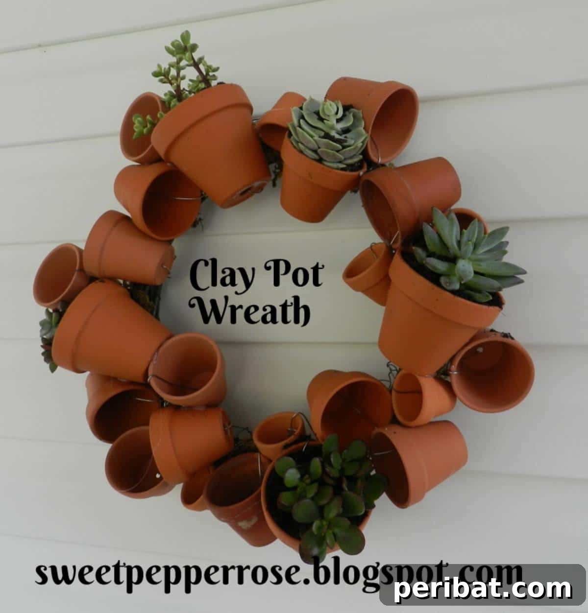 27 Terracotta Crafts to Elevate Your Outdoor Decor 15 DIY Mini Pot Wreath, a decorative wreath adorned with small clay pots.