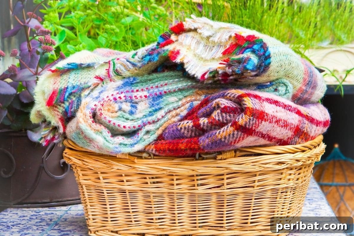Chicken-Powered Gardening: 20 Essential Tips 9 Folded colorful blankets in a rattan basket, ready for repurposing in the garden