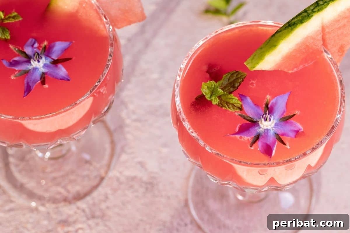 From Garden to Gourmet 10 Edible Flowers to Cultivate 5 A refreshing watermelon juice served in a glass, beautifully adorned with vibrant blue Borage flowers.