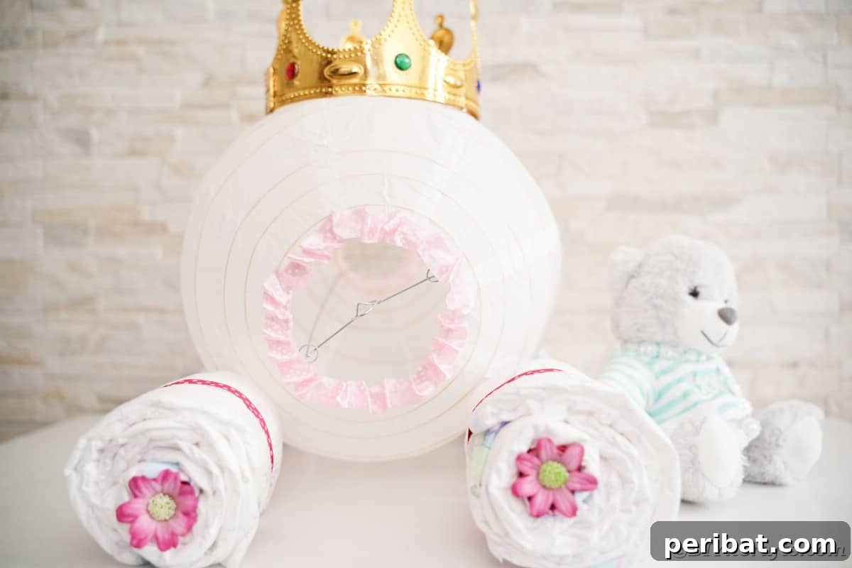 Enchanting Diaper Carriage Baby Shower Surprise 4 Cinderella carriage diaper cake on white table by white brick wall