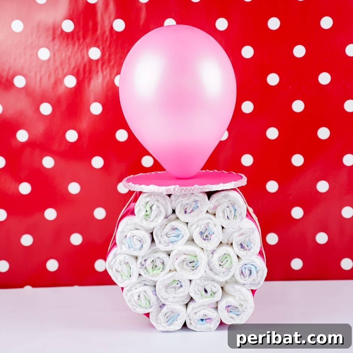 Craft Your Own Darling Pacifier Diaper Cake 2 Pacifier diaper cake standing up in front of red polka dot wall