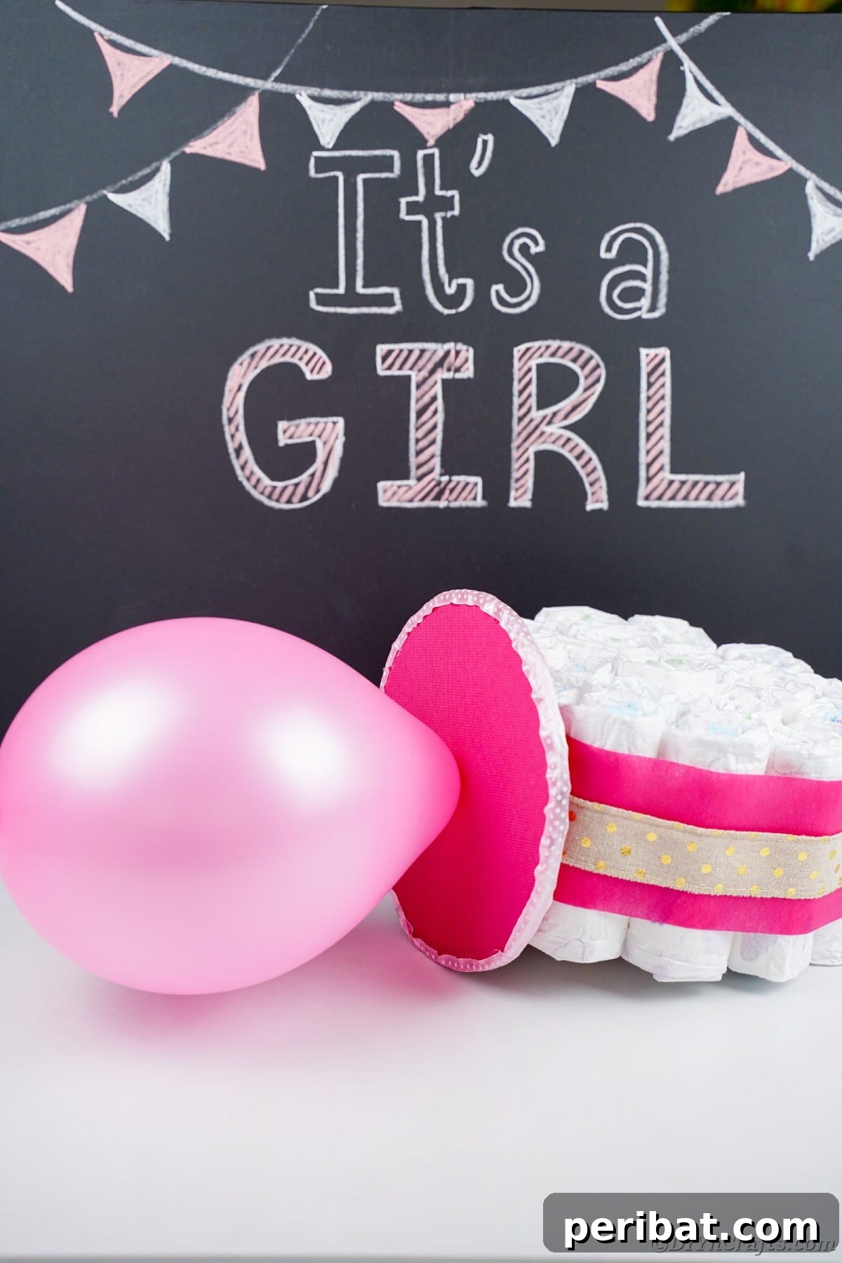 Craft Your Own Darling Pacifier Diaper Cake 3 Pink balloon and diaper pacifier on table