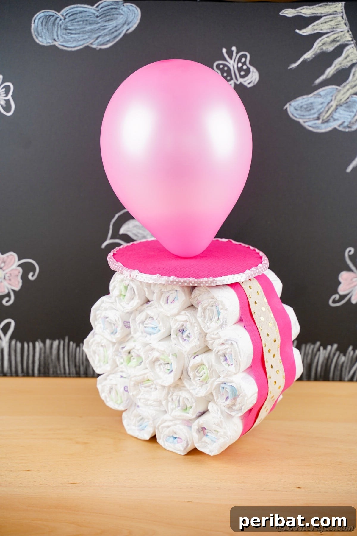Craft Your Own Darling Pacifier Diaper Cake 15 Chalkboard with flowers behind giant fake pacifier