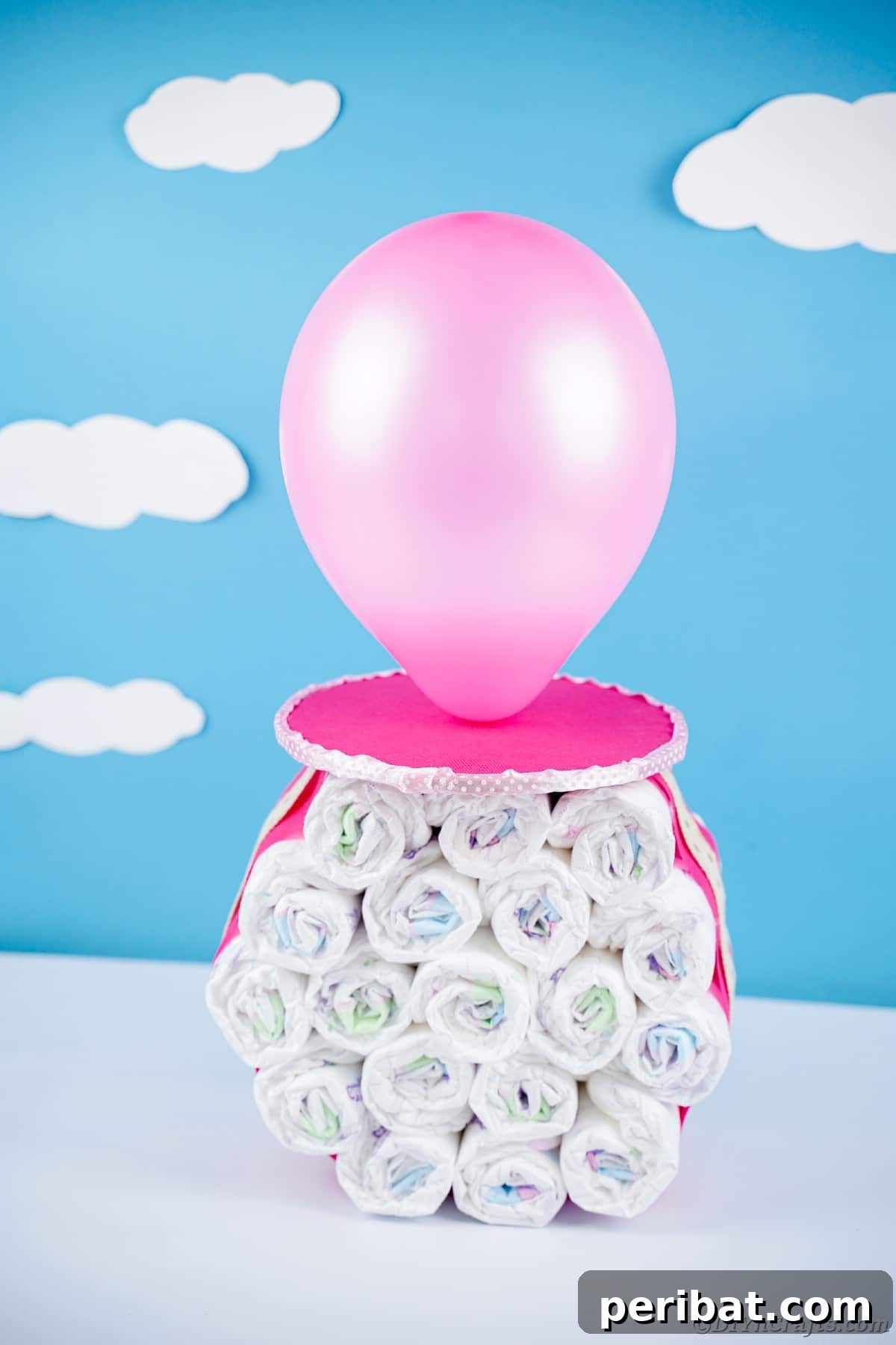 Craft Your Own Darling Pacifier Diaper Cake 16 Blue cloud background behind giant pink fake pacifier