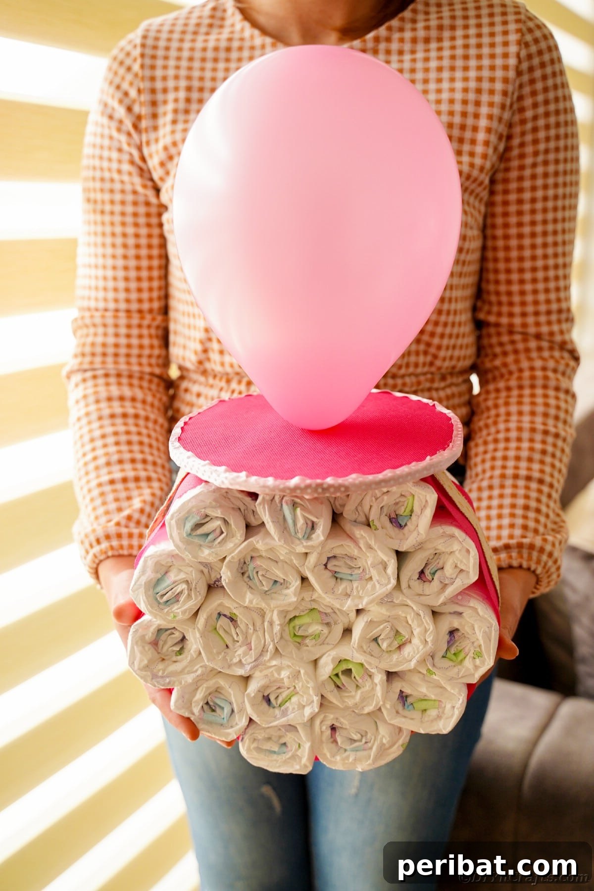 Craft Your Own Darling Pacifier Diaper Cake 5 Woman holding pink balloon diaper cake