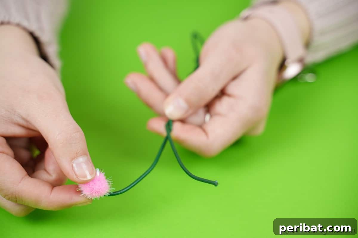 Fluttering Baby Delight: DIY Butterfly Diaper Cake 12 Carefully gluing a pink pom-pom onto the end of a floral wire, creating a soft and whimsical antenna tip.