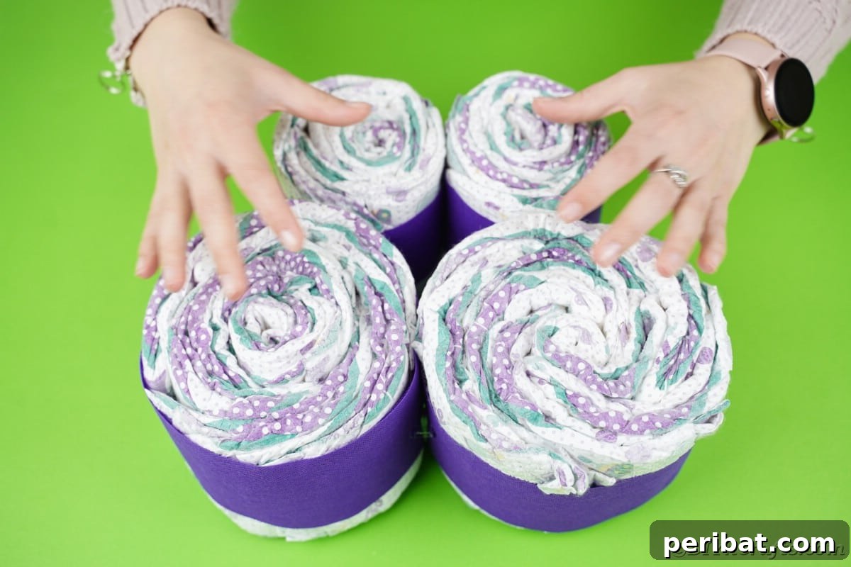 Fluttering Baby Delight: DIY Butterfly Diaper Cake 19 Four rolls of diapers, wrapped in purple paper, laid out for the butterfly wings.