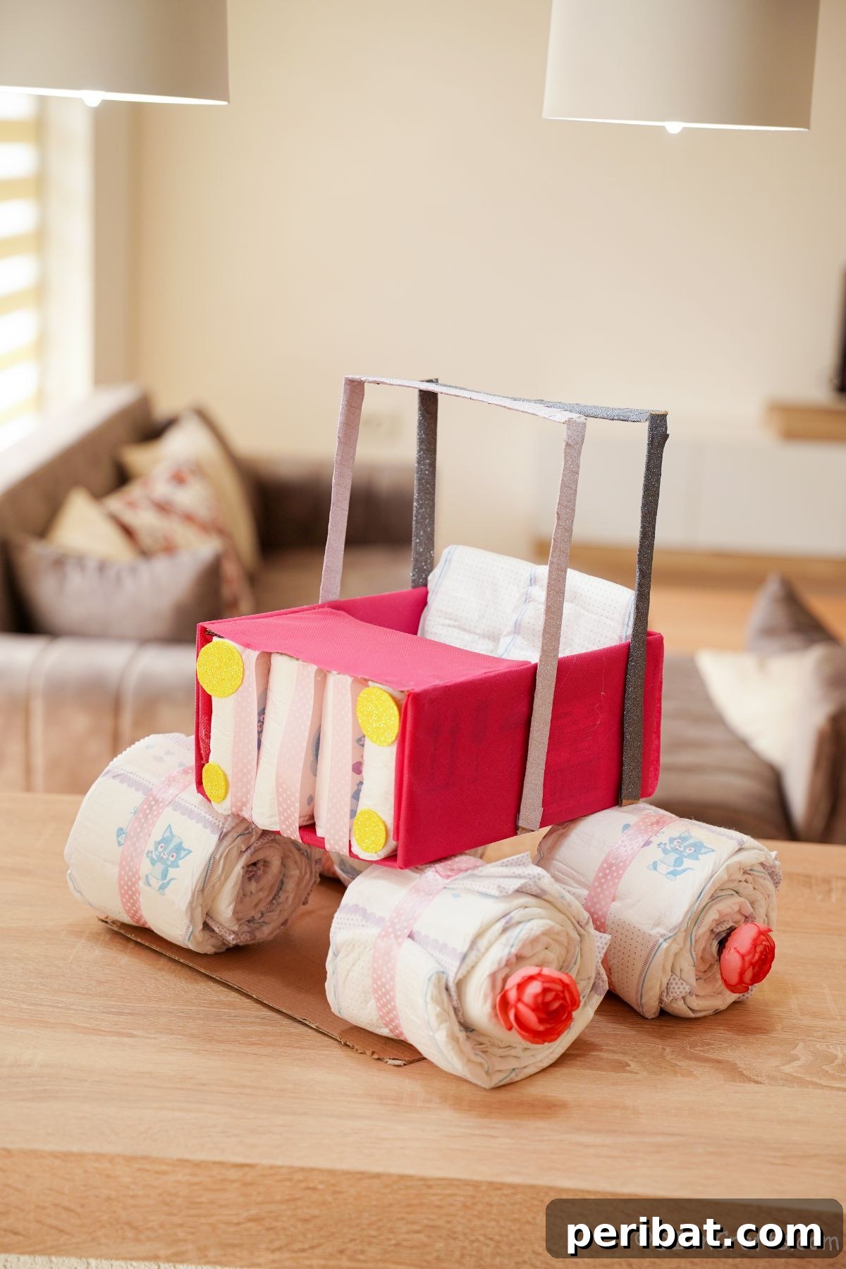 diaper cake with pink car top on table
