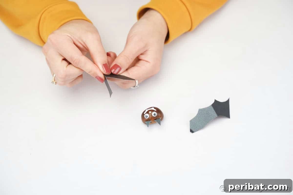 Hand folding black wing to attach to chestnut