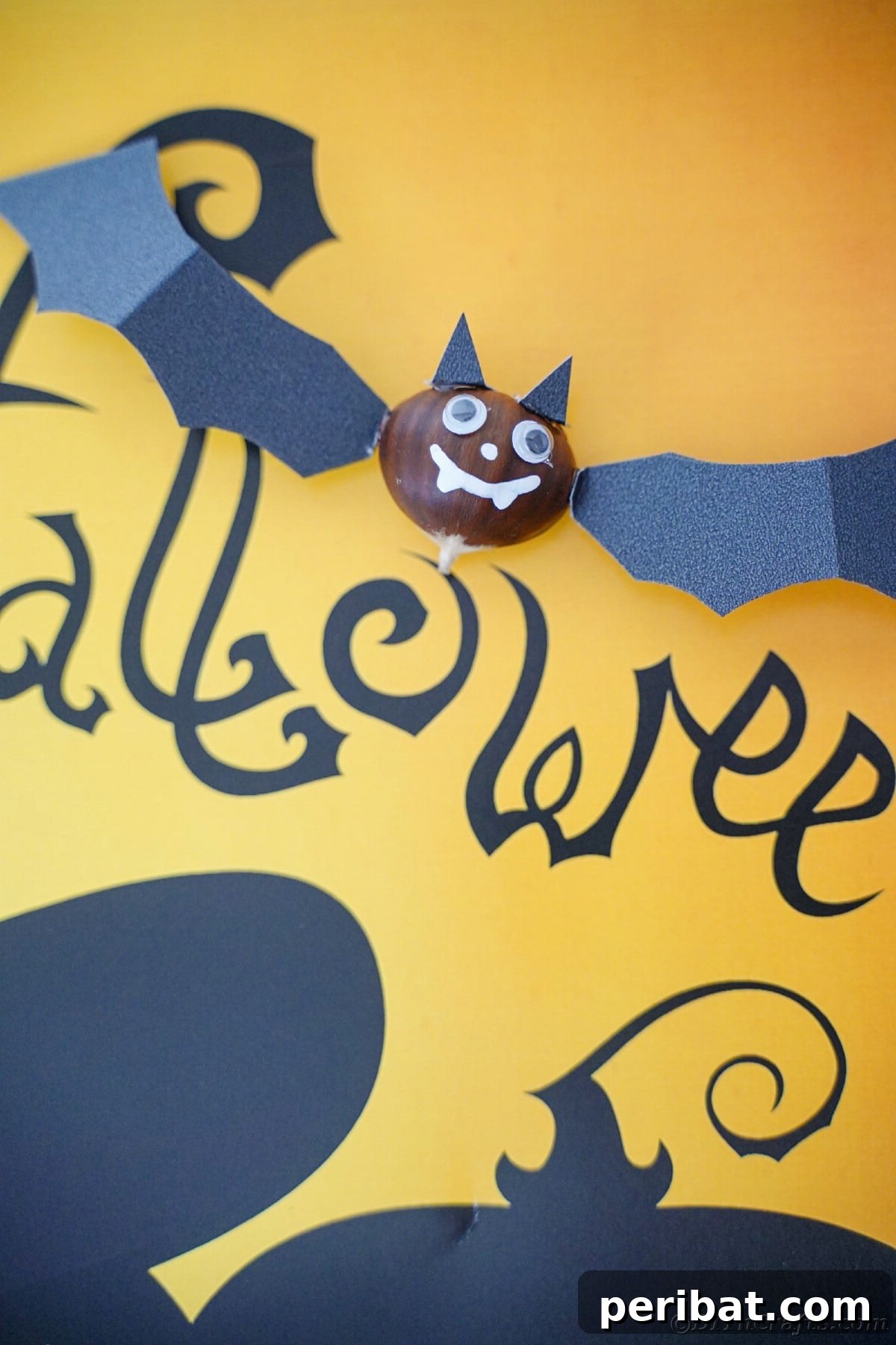 Chestnut bat laying on yellow and black halloween paper