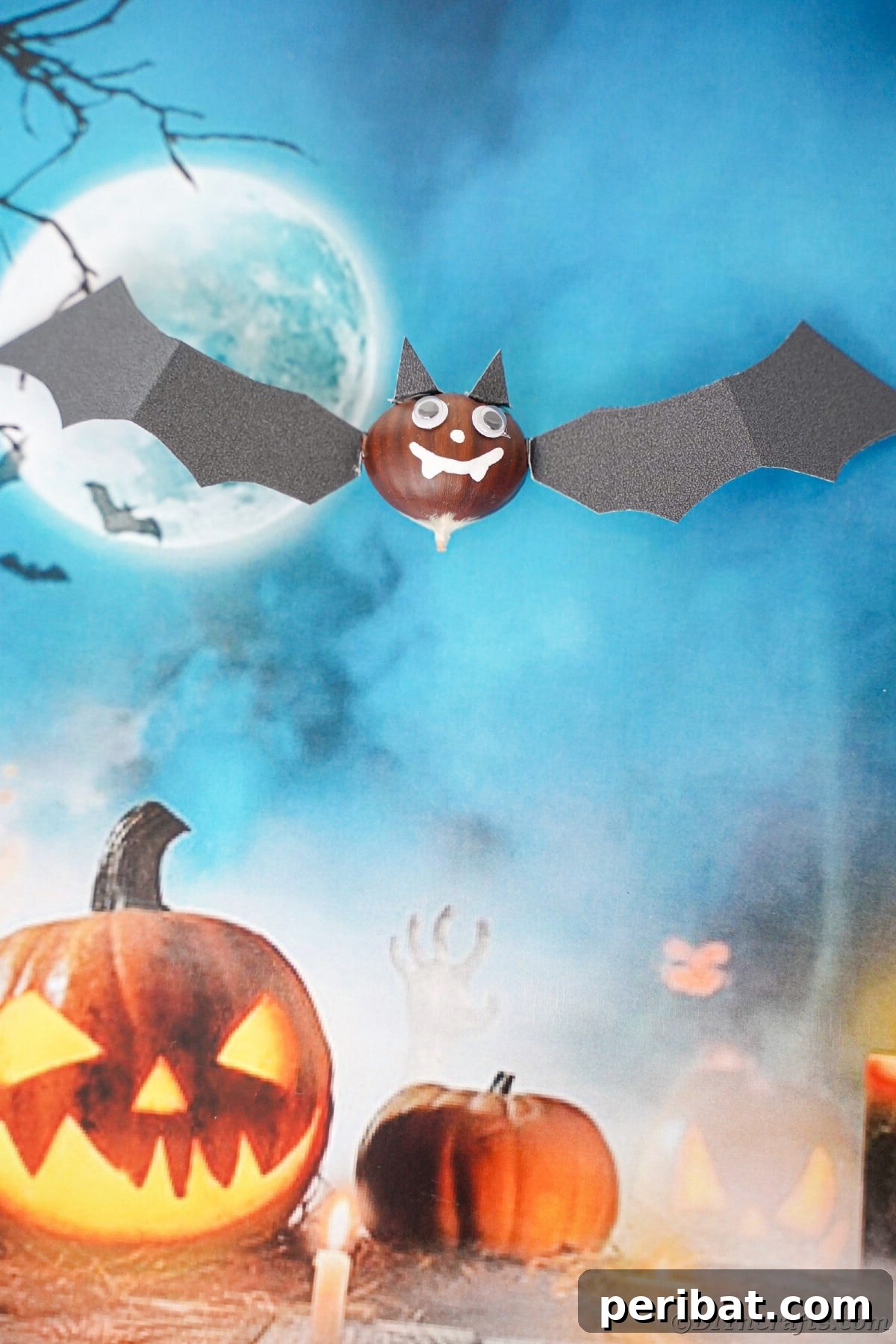 Crafted bat on top of blue scrapbook Halloween paper background