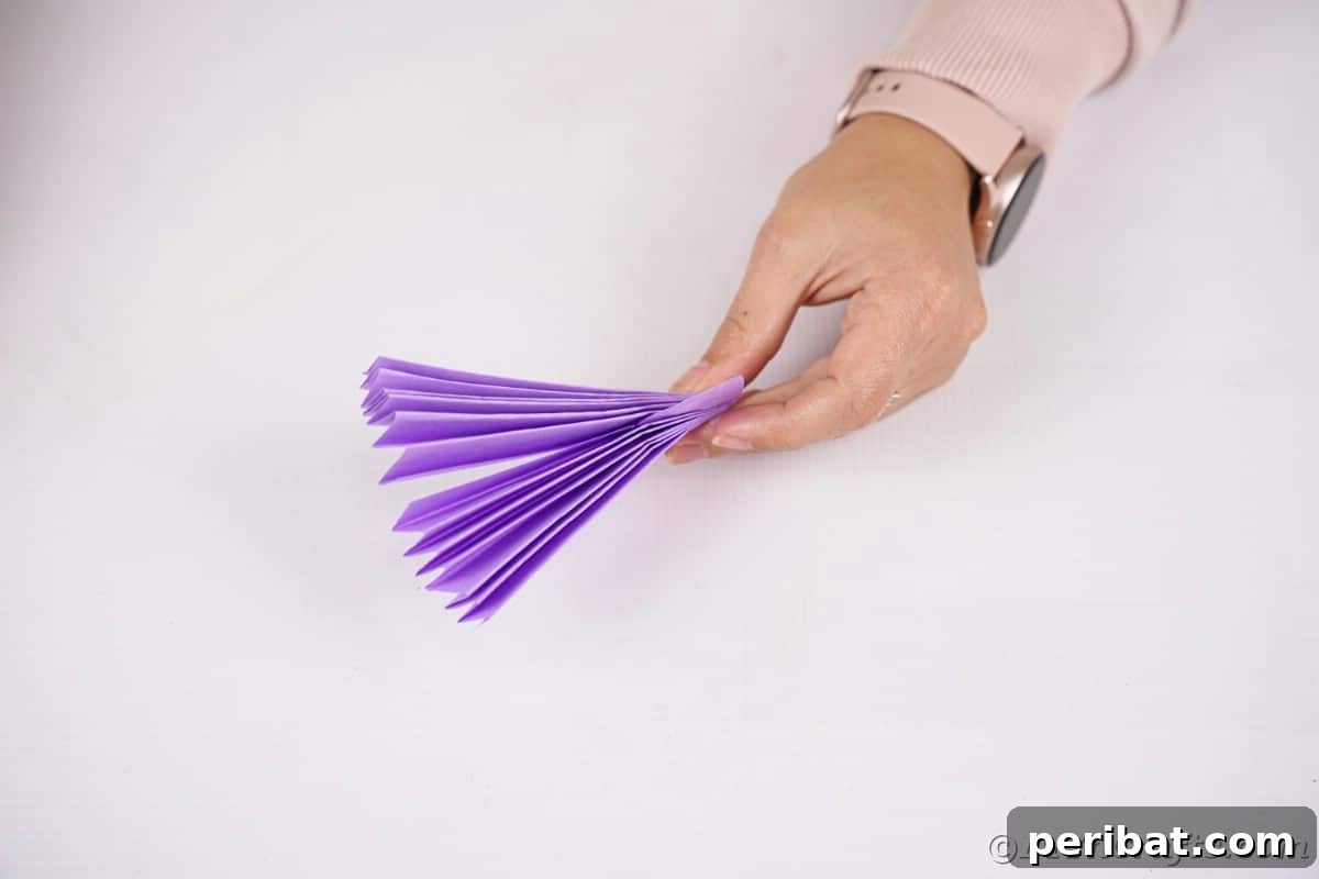 Fan-tastic Hedgehog Craft for Kids 24 Woman's hand holding purple paper fan