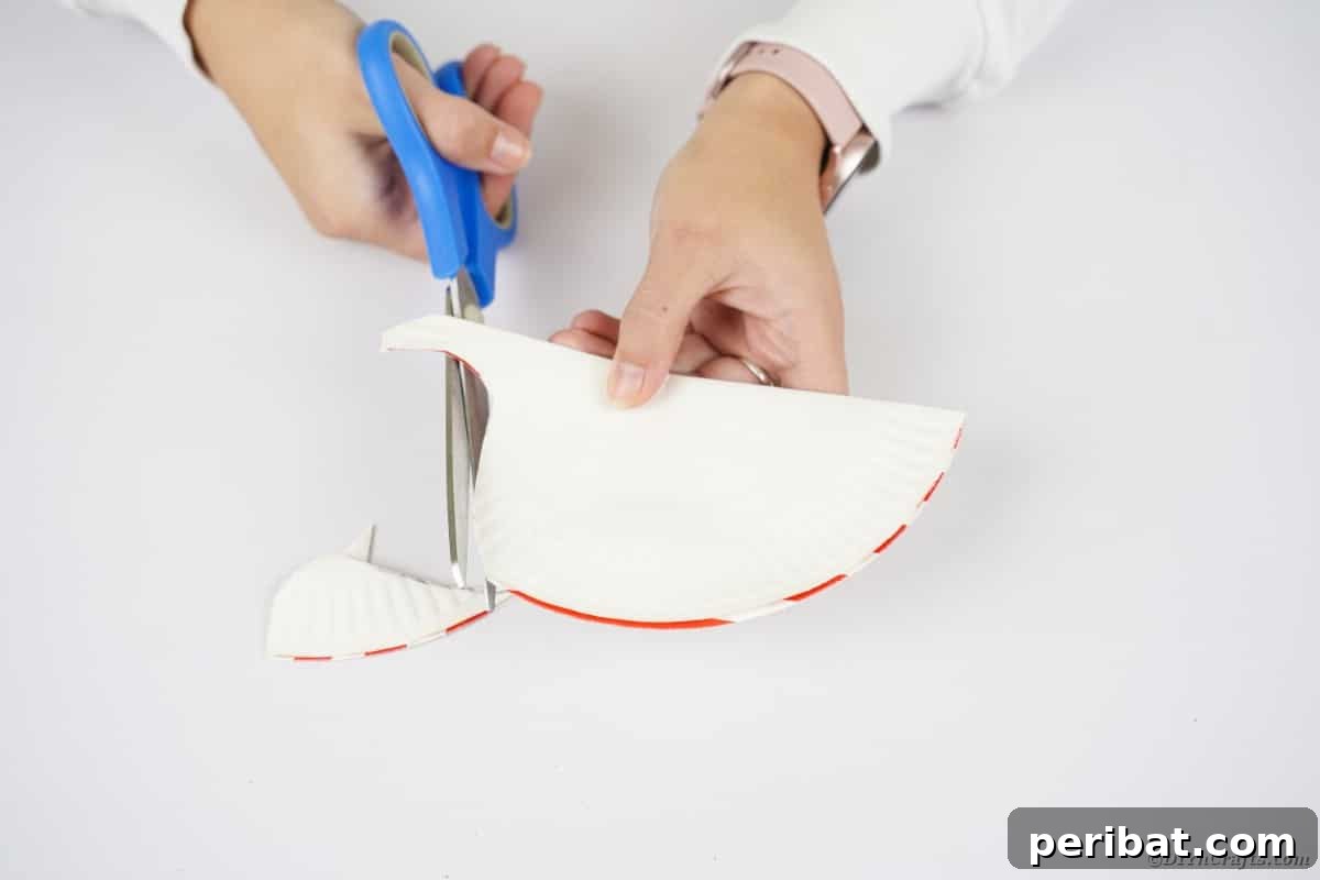 Hand cutting part of white plate off