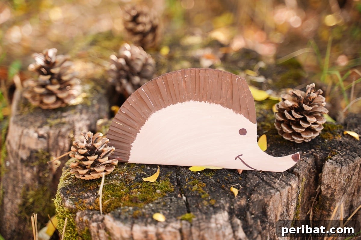 Stump with pinecones and paper hedgehog decoration
