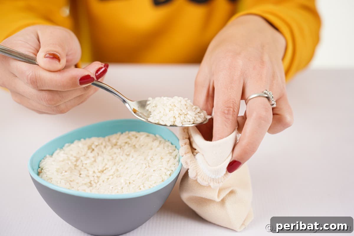 Effortless No-Stitch Fabric Hedgehog Creation 11 A hand carefully fills a cream-colored sock with white rice, preparing the base for a no-sew fabric hedgehog craft.