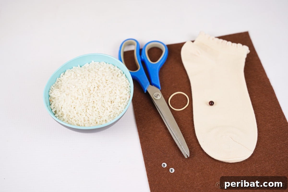 Effortless No-Stitch Fabric Hedgehog Creation 10 A neat arrangement of crafting supplies including brown felt, a cream-colored sock, and scissors, ready for a DIY project on a white table.