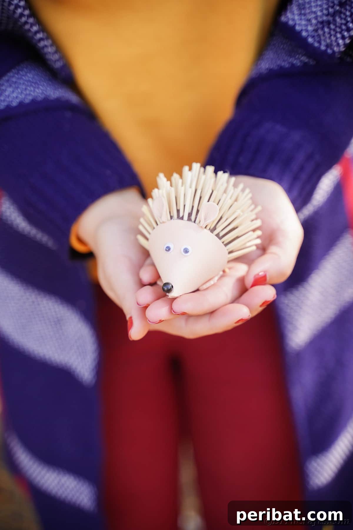 Rustic Foam Hedgehog: An Easy Autumn Craft for Kids 19 Woman in blue jacket holding hedgehog toy in hands