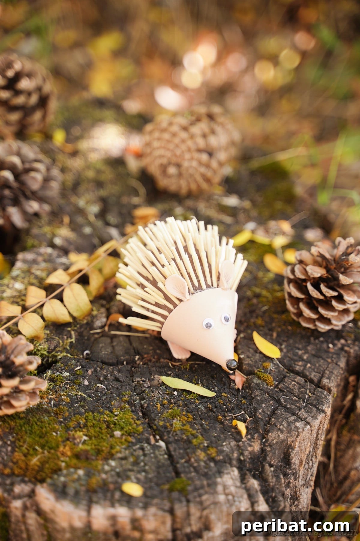 Rustic Foam Hedgehog: An Easy Autumn Craft for Kids 6 Foam hedgehog sitting on stump with pinecones