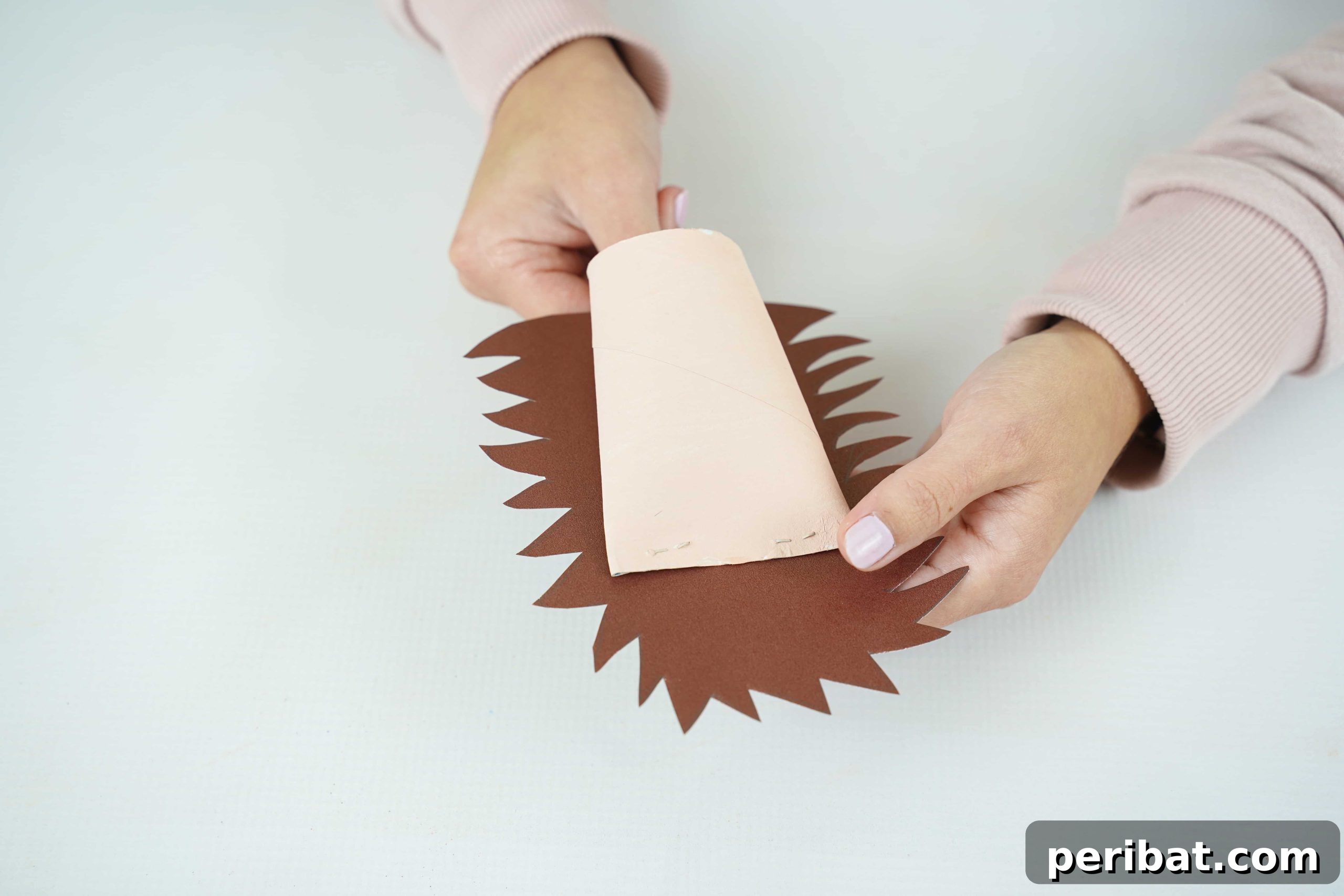 Charming Toilet Paper Roll Hedgehogs for Autumn 21 Hands gluing brown paper onto the light brown paper roll